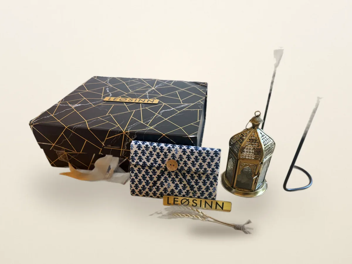 The LEØSINN signature black-and-gold gift box with a block-printed case and brass lantern